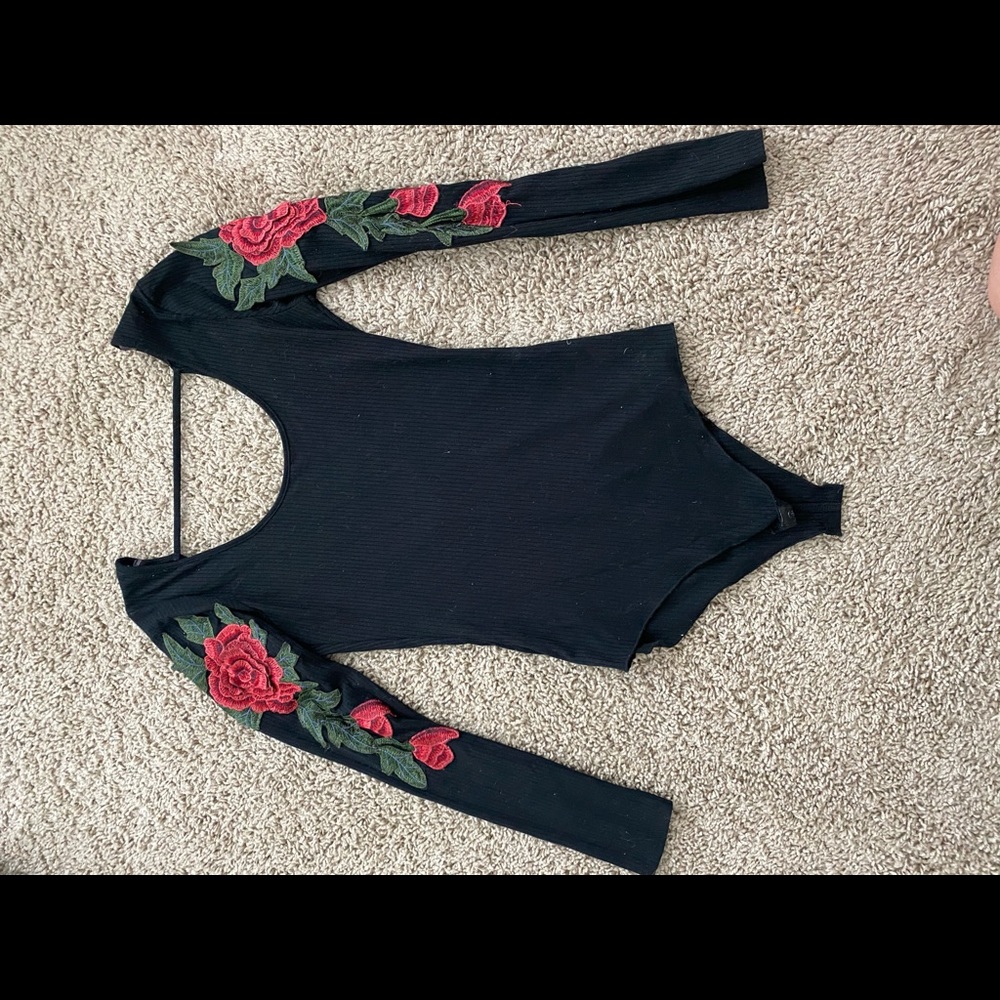 Black bodysuit with red rose details on sleeve